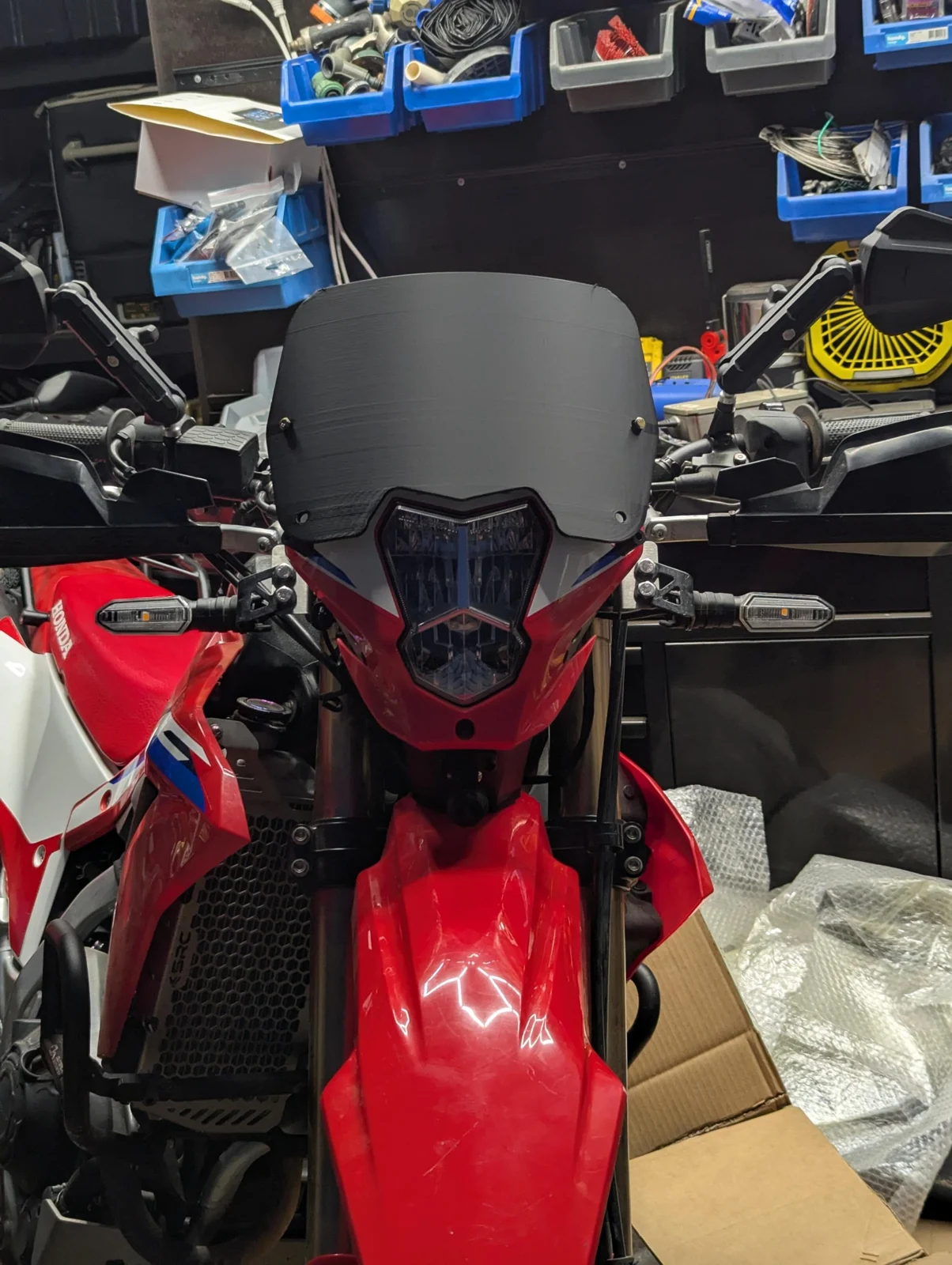 Straight-on front view showing the original Honda headlight and indicators in the C1 tower